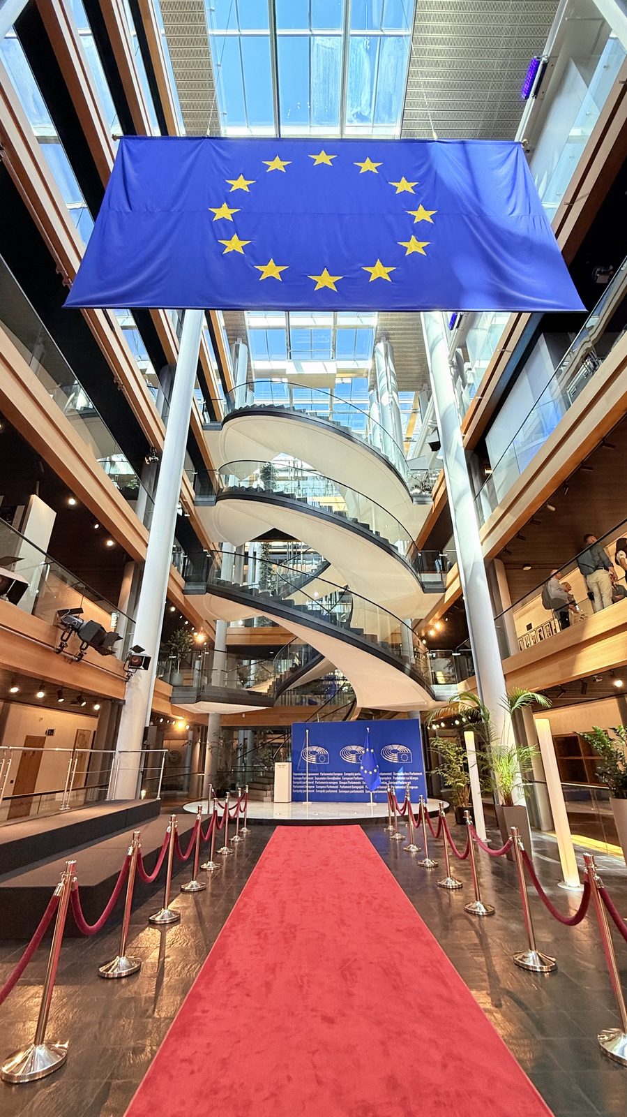 The grand staircase (escalier d'honneur) of the European Parliament, decorated with a red carpet and EU flag